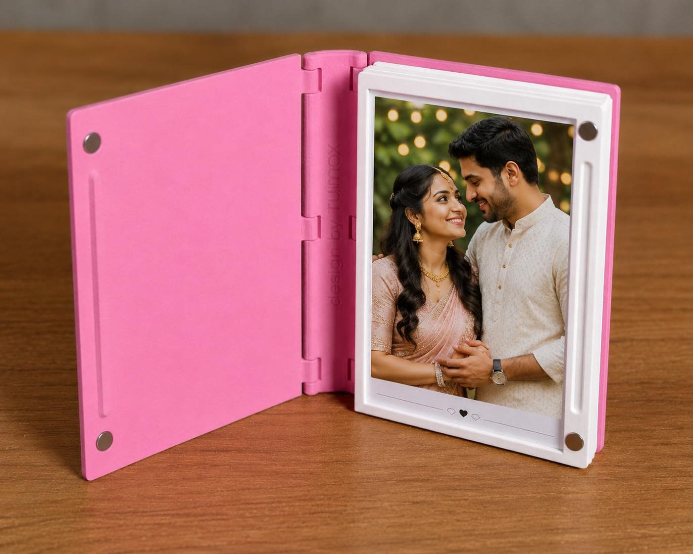 Pink photo album book opened to show a couple's photo
