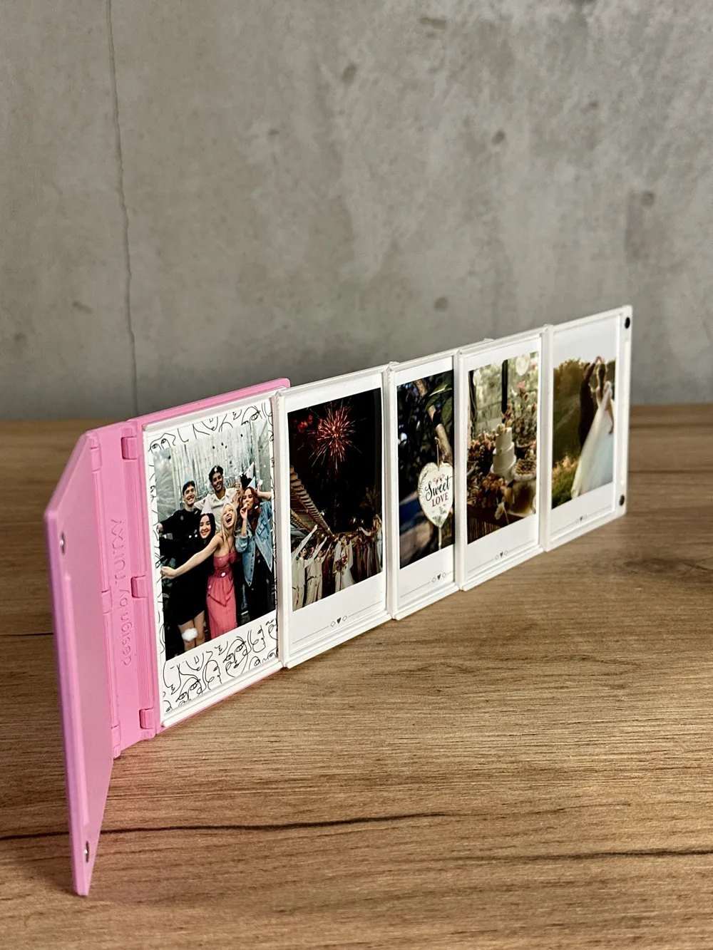 Album unfolded to show five photo frames in a row